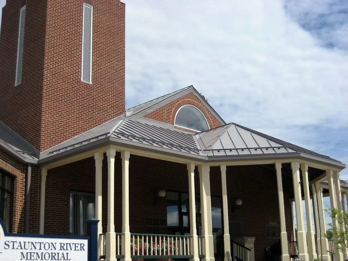 Skilled roofing craftsmen working on a residential roof in Quinnipiac
